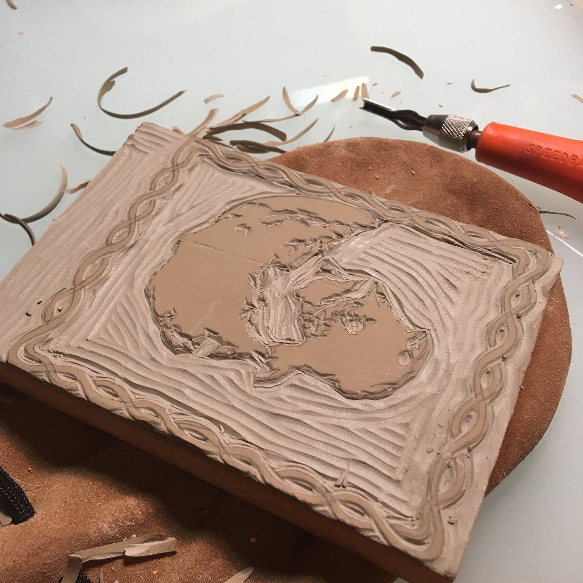 the block that Molly cut into that will support creating a map after first placing ink on the block, before having that block get pushed into paper to create the map.